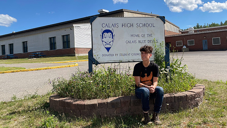 Andrea Gibson in front of Calais High School, Maine, 2021